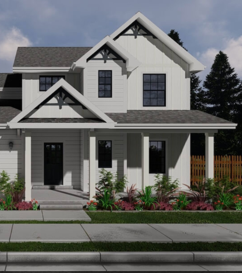 Beautiful modern white farmhouse with black window accents and landscaped yard.