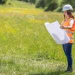 Developer reviewing construction plans on undeveloped land in High Springs, Florida, representing residential growth and homebuilder opportunities.