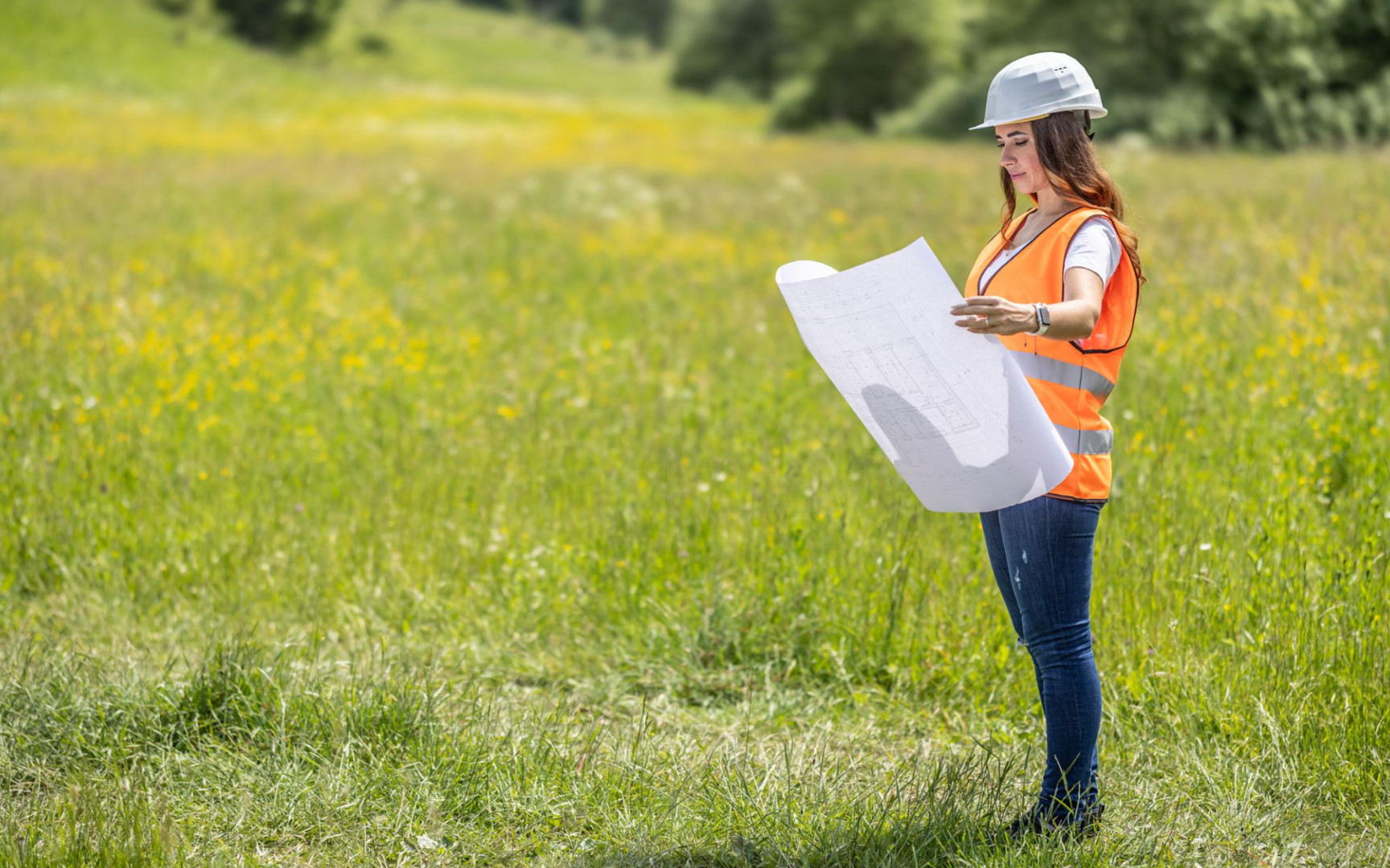 Developer reviewing construction plans on undeveloped land in High Springs, Florida, representing residential growth and homebuilder opportunities.