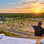 Builders reviewing plans overlooking multiple residential lots and new home construction in High Springs, Florida.